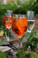 Cold, iced summery orange aperitif drink in a wine glass
