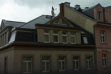 A tall building featuring a chimney prominently positioned at the very top of it, adding character to the urban skyline around it