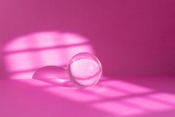 Abstract pink colored room background with window sun light trails and a glass sphere Backdrop with shadows of a window for product display defocused paper texture