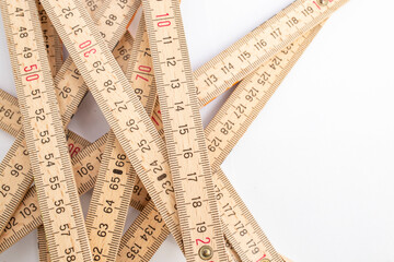 Abstract backdrop with a tangled wooden measuring meter, close up with copy space