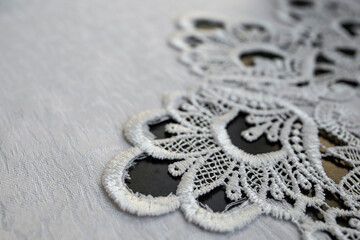 Embroidery pattern on a white table cloth, abstract detailed backdrop