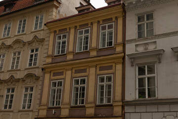 There is a distinctive row of buildings featuring a bright yellow building prominently positioned right in the middle of the scene