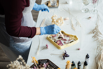 Crafting resin art with dried flowers, step-by-step process for beginners. Hands-on DIY home decor with natural elements, sustainable techniques.