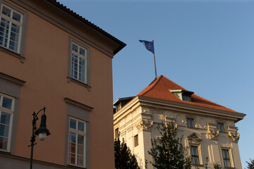 There is a tall building that has a flag prominently placed on top of its roof, easily visible from various points in the city