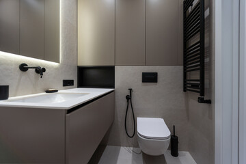 White toilet hanging on a gray wall
