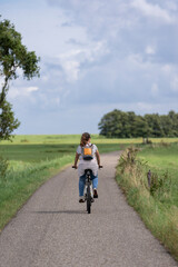 Mujer en bicicleta por la naturaleza un dia soleado 