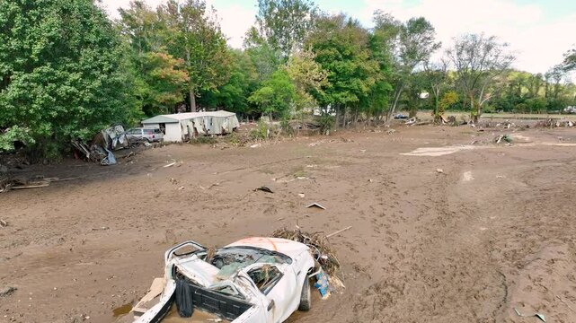 Low shot of destruction, 1 week after tropical storm Helene, in a devastated viver valley near Swannanoa, NC.