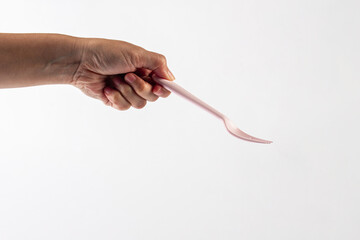 Pink fork and hand isolated on white background.