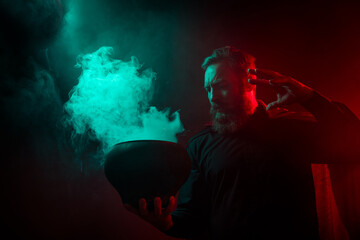 Photo of scary wizard warlock hold cauldron spell mystical ritual halloween spooky night isolated...