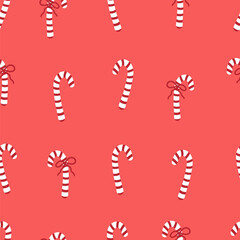 Candy cane with red bow seamless pattern. Christmas sweets backdrop. Festive ornament with candies on red background.
