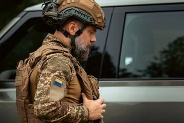 profile portrait of a military man in a helmet and body armor