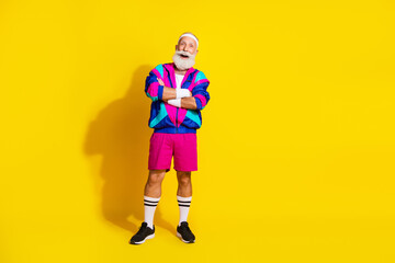 Full length photo of sportive cool modern pensioner dressed vintage jacket arms folded emtpy space isolated yellow color background