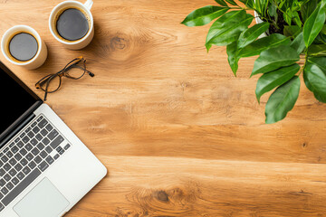 A top view of a marketing team developing a social media campaign, with laptops and strategy notes