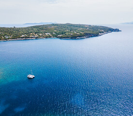 Aerial view of sailboat anchored near coastal island landscape