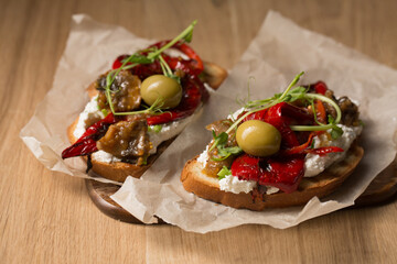 Sandwiches with cheese spread, olives and grilled pepper