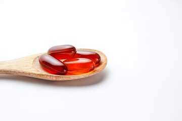 wooden spoon with soft gels, Fish oil capsules, omega 3, omega 9, vitamin D, vitamin E