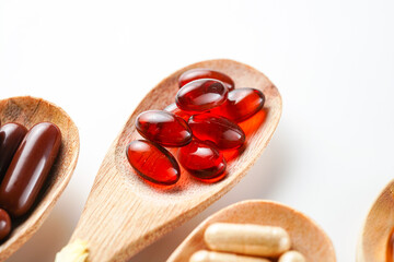 Vitamin capsules in a wooden spoon, soft gels, Fish oil capsules, omega 3, omega 9, vitamin D, vitamin E