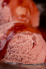 red strawberry-flavored ice cream in a glass bowl