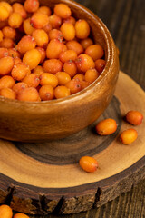 orange sea buckthorn in a wooden bowl
