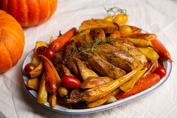 Baked chicken fillet with vegetables including sweet potatoes and pumpkin. Concept of saving resources, alternative to turkey on thanksgiving day