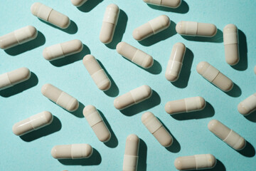 Group of pills capsules, the nutritional supplements, vitamins medicine tablets on blue background