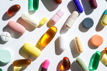 A lot of colorful medication pills capsules tablets softgel supplements, fish oil, vitamin, omega 3
