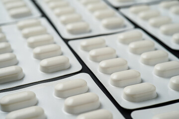 Pills Medicine tablet capsules in blister pack on a black background