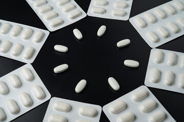 Antibiotic pills Medicine tablet capsules in blister pack on a black background