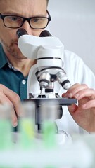 Man scientist using microscope in laboratory. Microbiology science concept