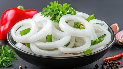 A close-up shot of sliced onions in a bowl alongside fresh herbs and spices highlighting their texture and layers