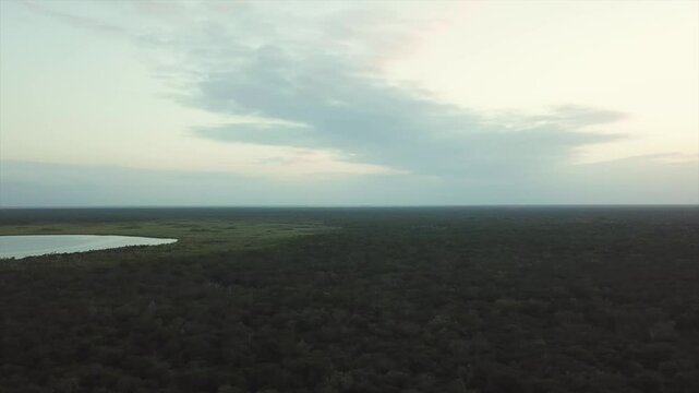 Aerial view of Pino Suarez (or Nolalitos) lagoon and the sun setting in the jungle, Tulum, RIviera Maya, Mexico