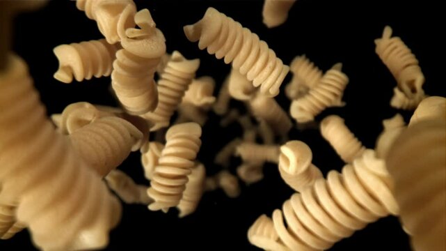 Fusili pasta falls down. Filmed on a high-speed camera at 1000 fps. High quality FullHD footage