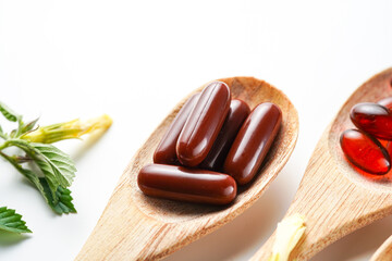 Vitamin capsules in a wooden spoon, soft gels, Fish oil capsules, omega 3, omega 9, vitamin D, vitamin E