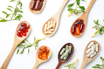Vitamin capsules in a wooden spoon, soft gels, Fish oil capsules, omega 3, omega 9, vitamin D,...