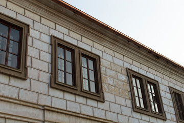 Fototapeta premium An impressive brick building featuring a significant number of windows on its exterior, creating a striking visual appeal for onlookers