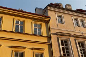 There are two yellow buildings prominently displayed, set against a vivid blue sky that serves as a picturesque backdrop