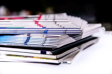 Pile of magazines on the table, close-up. Selective focus.