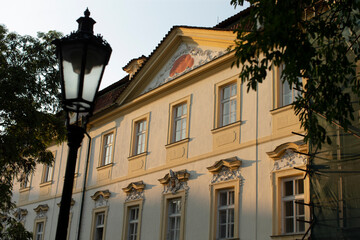 A large and impressive building stands prominently with a charming lamp post situated in front of it for illumination during the night