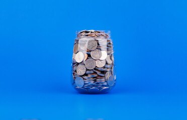 Saving coins in a piggy bank creates savings discipline, financial planning, financial growth and investment.