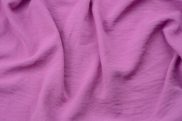 Close-up of soft, textured lilac fabric draping elegantly on a surface