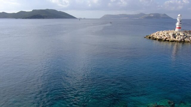 harbor with boat of Kas Turkey with becon, Tranquil bay with iconic Kas lighthouse. picturesque haven where azure waters meet coastal serenity,