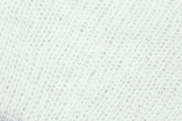 Textured close-up of lightweight white mesh fabric for fashion and design purposes
