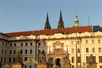 There is a large and impressive building that features a beautiful statue right in front of it,...