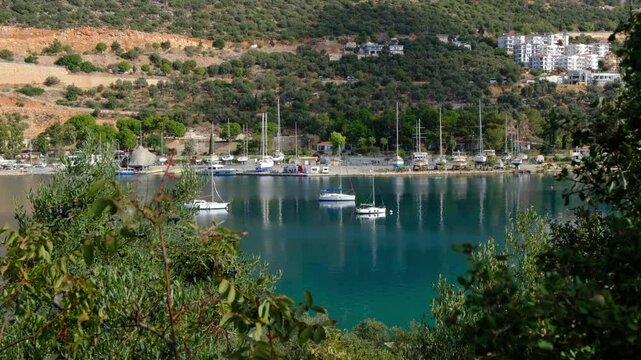 Yachts and boats moored in the harbor of Kas, Turkey. The sun is shining, and water is calm. Sailing paradise , Yachts and boats gracefully navigate azure waters against of this coastal