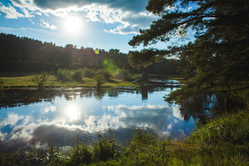 a serene lakeside landscape during what seems to be either early morning or late afternoon