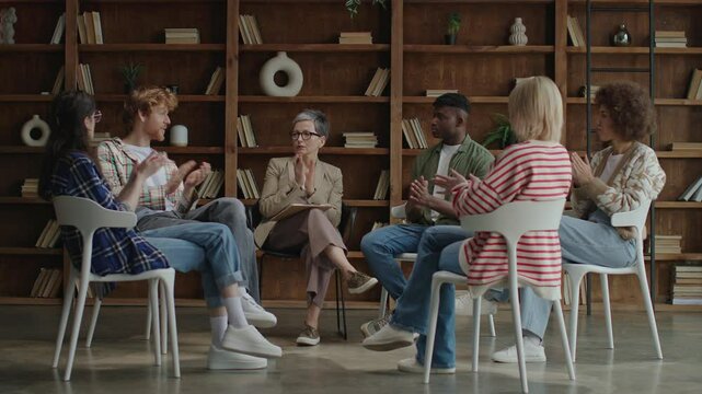 In a contemporary setting, six diverse young adults convene in a circle for a therapeutic session, fostering growth and solidarity