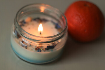 Banner. White candle burns on a dark background. Place for the text, postcard stock photo. Winter day. Gifts cards idea