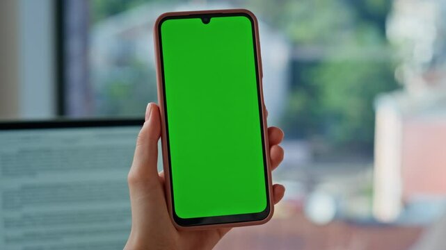 Fingers scrolling mockup mobile phone in modern office closeup. Unknown woman