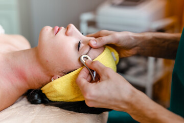 Facial massage with gouache stone in a beauty salon