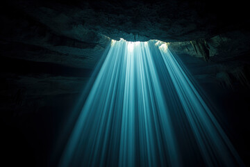 A mesmerizing image of a powerful beam of light streaming through a cave's opening, casting striking shadows and highlighting the rugged interior features and textures in a cenote in Mexico